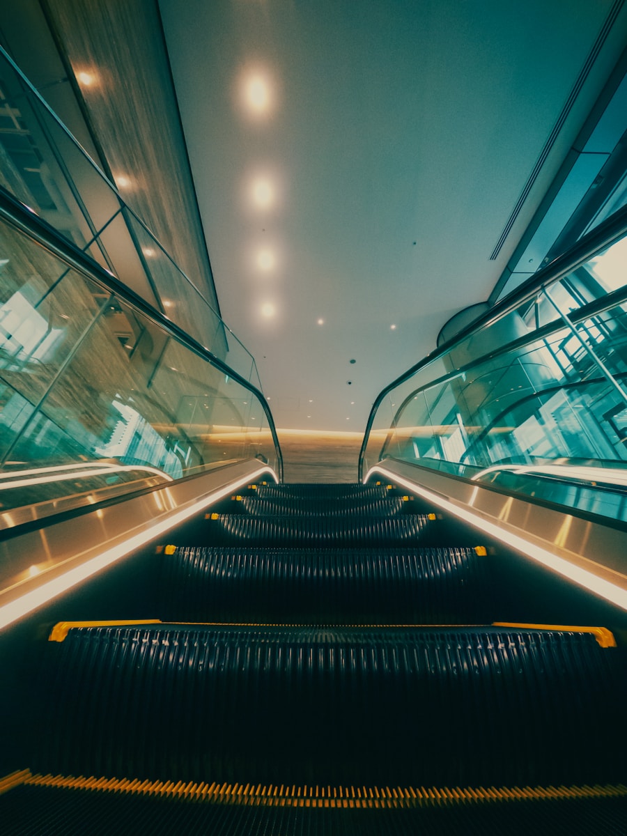 An escalator in a building with a sky background